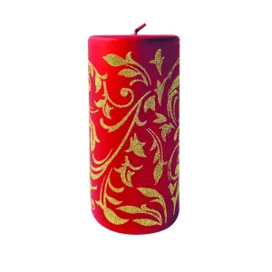 Candela cilindrica con decorazione di foglie glitter oro, disponibile in diverse misure e colori.